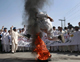 A demonstrator jumps over burning tyres during an anti-American rally in Peshawar organised by the Islamic political party Jamaat-e-Islami (Photo: Reuters)