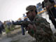 A Pakistani soldier adjusts his weapon while keeping guard at the scene of the drive-by shooting(Credit: Reuters)