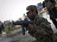 A Pakistani soldier adjusts his weapon while keeping guard at the scene of the drive-by shooting(Credit: Reuters)
