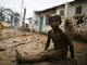 A child sits on mud caused by Typhoon Ketsana on Friday(Photo: Reuters)
