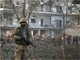 A soldier stands guard in front of the ISI building in Peshawar, the site of a suicide bomb blast on 13 November 2009(Photo: K Parvez/Reuters)