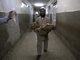 A father carries his son, who was injured in the suicide bomb attack, through the halls of a hospital in Peshawar after he was treated.(Photo: Reuters)