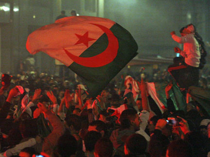 Algerian team soccer fans celebrate with a national flag in Marseille after the victory of Algeria over Egypt (Photo: Reuters)
