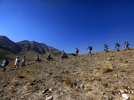 Afghan members of a demining squad walk with their demining dogs down a mountain after a mine clearing operation outside the village of Tangi Saidan on Saturday. Afghanistan is still struggling to remove mines from remote areas after three decades of war.(Photo: Reuters)