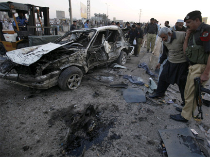 Security officials survey the site of Saturday's suicide bomb blast in Peshawar(Photo: Reuters)