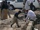 Security officials survey the site of a suicide blast in Rawalpindi, near the capital Islamabad Monday
(Photo: Reuters)