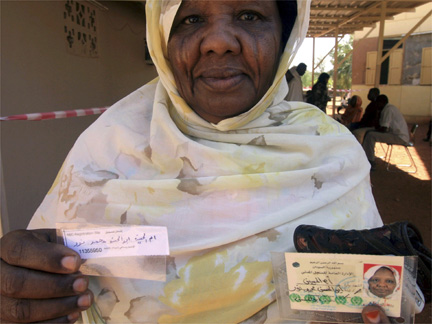 A woman displays her identity card after registering for Sudan's elections in Khartoum (Photo: Reuters)