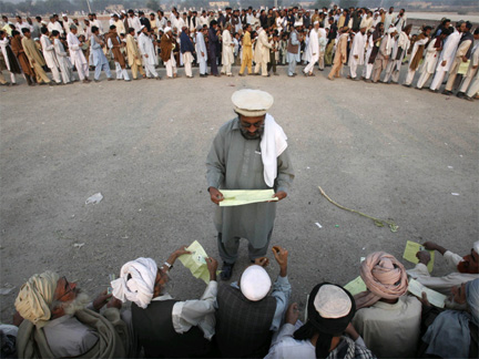 A worker checks the identity cards of men fleeing a military offensive in South Waziristan(Photo: Reuters)