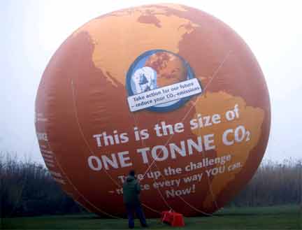 An environmental activist anchors a balloon outside the congress centre in Copenhagen before the opening of the UN climate chaneg conference, 7 December 2009(Photo: Pawel Kopczynski/Reuters)