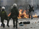 A protester throws a stone at riot police in central Athens, 6 December 2009(Photo: John Kolesidis/Reuters)