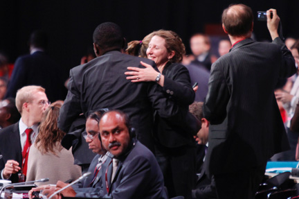 Delegates embrace as the COP15 "takes note of the Copenhagen accord(Photo: Reuters)
