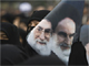 A government supporter holds a poster with images of Iran's leaders during a protest in Tehran(Photo: Reuters)