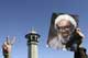 An opposition supporter holds up a picture of Montazeri (Photo: Reuters)