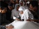 Wahid's wife, Sinta Nuriyah, is accompanied by her daughters as they mourn in front of Wahid's body before the funeral at their home in Jakarta(Photo: Reuters)