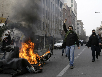  Iranian protesters, with their faces covered, shout during fierce clashes in central Tehran December on Sunday
(Photo: Reuters)