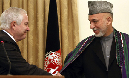 US Secretary of Defense Robert Gates shakes hands with Afghan President Hamid Karzai at the Presidential Palace in Kabul.Photos: Reuters/Justin Sullivan