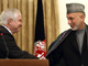 US Secretary of Defense Robert Gates shakes hands with Afghan President Hamid Karzai at the Presidential Palace in Kabul.Photos: Reuters/Justin Sullivan