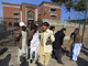 Journalists assist an injured man at the gate of the press club in Peshawar on 22 December(Photo: Reuters)