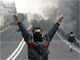 An Iranian protester, with his face covered, flashes victory signs during clashes in central Tehran on Sunday(Photo: Reuters)