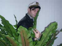 French electronic music producer Danton Eeprom hiding in the bushes at les Trans'Photo: RFI