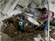 Men trying to reach trapped survivors at the Montana hotel that collapsed after the earthquake in Port-au-Prince(Photo: Reuters)
