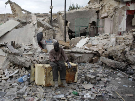 A man rests after looking for useful materials among the rubble in Port-au-Prince (Photo: Reuters)