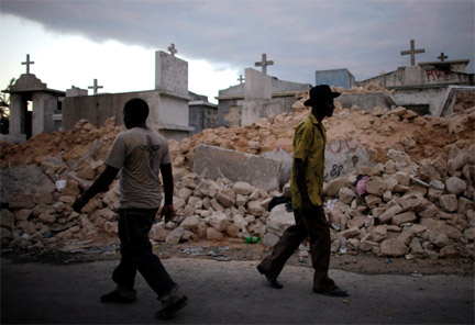 People walk in front of a cemetery destroyed by the earthquake in Port-au-Prince on 14 January, 2010(Photo: Reuters)