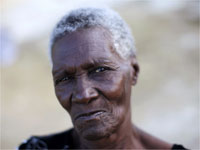 A Haitian woman outside her tent at a makeshift refugee camp in Port-au-Prince(Credit: Reuters)