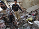Pakistani security officials stand amid debris after the explosion(Photo: Reuters)