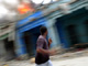 A man runs in front of a burning building in downtown Port-au-Prince.Photo: Reuters