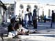 Injured people rest outside Port-au-Prince's cathedral after the earthquake (Credit: Reuters)