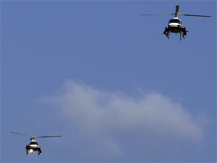 Angolan police helicopters circle above the Olympic Village(Photo: Reuters)