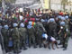A line of soldiers guards a crowd of local people coming to get humanitarian aid in Port-au-Prince(Photo: Reuters)