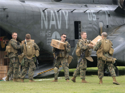 US marines carry aid supplies after landing in a rural area outside Port-au-Prince(Photo: Reuters)