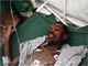 Earthquake survivor Evans Monsigrace, 28, lies on a stretcher inside a University of Miami field hospital in Port-au-Prince (Credit: Reuters)