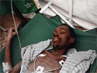 Earthquake survivor Evans Monsigrace, 28, lies on a stretcher inside a University of Miami field hospital in Port-au-Prince (Credit: Reuters)