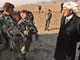 French Defence Minister Hervé Morin (R) sporting an Afghan head dress speaks to paratroopers on a visit to Afghanistan in 2008(Photo: AFP)