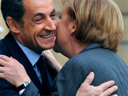 French President Nicolas Sarkozy and German Chancellor Angela Merkel kissing at the Elysee Palace in Paris on 4 February(Photo: Reuters)