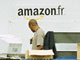 Des employés du site Amazon.fr travaillent dans l'entrepôt de stockage.  

		Photo AFP
