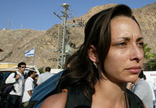 Une jeune femme passe le poste frontière entre Egypte et Israël à Eilat. Les touristes israéliens quittent en masse le Sinaï.  

		(Photo: AFP)
