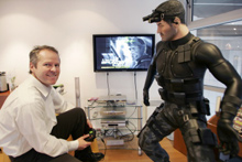 Yves Guillemot, l'un des cinq frères fondateurs de la société Ubisoft et un de ses personnages de jeu vidéo dans son bureau en banlieue parisienne.(Photo : AFP)