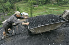 Un mineur chinois pousse un wagonnet de charbon. Cette matière première regorge dans le sous-sol de ce pays dont les besoins en énergie explosent.(Photo: AFP)