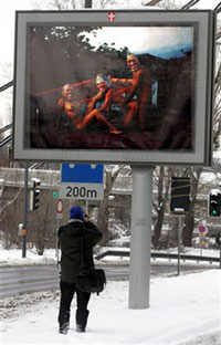 La campagne d'affichage à Vienne fait scandale. Trois personnes nues, portent les masques de George W. Bush, de la reine Elizabeth II, et de Jacques Chirac.(Photo : AFP)
