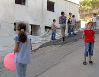 Dans la rue du quartier de Safafa, des enfants continuent à jouer à l’endroit où la roquette s’est abattue la veille. 

		(Photo : Sonia Chironi / RFI)