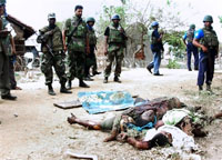 Des soldats sri-lankais devant des cadavres de rebelles tamouls tués dans des combats à Muttur le 5 août. 

		(Photo : AFP)