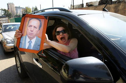 A Beyrouth, une femme brandit le portrait de Jamil Sayyed, un des quatre généraux libérés, le 29 avril 2009.  (Photo : AFP