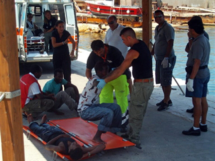 Les médecins de la Croix Rouge italienne apportent les premiers soins aux cinq rescapés accueillis sur l'île de Lampedusa. Ils étaient dans un « état critique » selon la police.( Photo : Mauro Seminara / AFP )