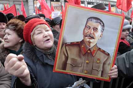 Портрет Сталина в руках участника акции коммунистов в Москве 23 февраля 2010.© REUTERS