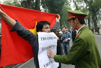 Một thanh niên biểu tình đối mặt với một công an ở Hà Nội