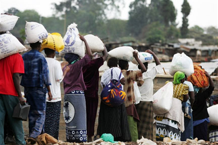 Des Kenyans de Kibera transportent des sacs de riz, distribués le 15 janvier 2008, par le Programme alimentaire mondial.(Photo : AFP)